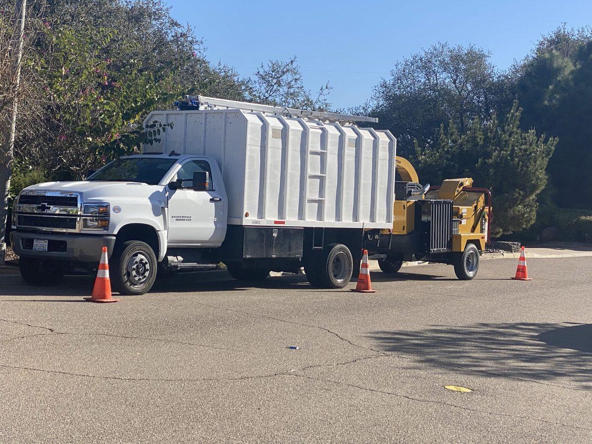 Chipper hauling cut brush off a North County property after fire clearance